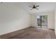 Inviting room featuring a ceiling fan and sliding door to backyard at 7122 Barclay Ave # B, Spring Hill, FL 34609
