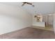 Bright room featuring ceiling fan, chandelier, and view of kitchen and front door at 7122 Barclay Ave # B, Spring Hill, FL 34609