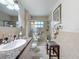 Bathroom showcasing a glass shower, a vanity with granite countertop, and decorative towels at 7133 Trenton Pl, New Port Richey, FL 34653