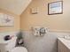 Half-bathroom featuring tile walls, decorative artwork, and modern fixtures at 7133 Trenton Pl, New Port Richey, FL 34653