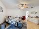 Bright bedroom featuring hardwood floors, a ceiling fan, neutral walls, and a large chest at 7133 Trenton Pl, New Port Richey, FL 34653