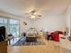 Spacious bedroom with a ceiling fan, light hardwood floors, and a sliding glass door to the outdoors at 7133 Trenton Pl, New Port Richey, FL 34653