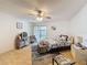 Bedroom with a ceiling fan, hardwood floors, a sliding glass door, and a decorative dresser at 7133 Trenton Pl, New Port Richey, FL 34653