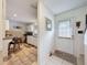 Welcoming foyer with tile flooring flows into the updated kitchen area, providing a seamless transition at 7133 Trenton Pl, New Port Richey, FL 34653
