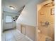 Hallway featuring half-bath with tile wainscoting and front door access at 7133 Trenton Pl, New Port Richey, FL 34653