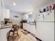 Eat-in kitchen features white cabinets, stainless steel appliances, and a bar-height counter with seating at 7133 Trenton Pl, New Port Richey, FL 34653
