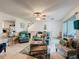 Bright living room with view to the kitchen, stairwell, and access to screened lanai at 7133 Trenton Pl, New Port Richey, FL 34653