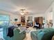 Spacious living room with ceiling fan, comfortable seating, and sliding glass door to lanai at 7133 Trenton Pl, New Port Richey, FL 34653