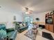 Comfortable living room featuring sliding glass door to the screened lanai and a ceiling fan at 7133 Trenton Pl, New Port Richey, FL 34653