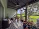 Relax in this screened porch with ceiling fan, overlooking backyard with lush landscaping at 7133 Trenton Pl, New Port Richey, FL 34653