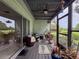 Relax in this screened porch with ceiling fan, overlooking backyard with lush landscaping at 7133 Trenton Pl, New Port Richey, FL 34653