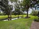 Scenic backyard with a tranquil pond reflecting the surrounding trees, providing a serene outdoor retreat at 7135 Trenton Pl, New Port Richey, FL 34653