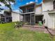 Picture of a backyard featuring a two-story lanai with steps leading to a well-kept lawn at 7135 Trenton Pl, New Port Richey, FL 34653