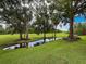 Landscaped backyard featuring a tranquil pond reflecting the sky and trees, offering a serene view at 7135 Trenton Pl, New Port Richey, FL 34653