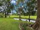 Beautiful backyard featuring a serene pond and lush landscaping, creating a peaceful outdoor space at 7135 Trenton Pl, New Port Richey, FL 34653
