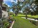 Serene backyard with lush lawn, mature trees, and a tranquil creek at 7135 Trenton Pl, New Port Richey, FL 34653