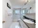 Bathroom featuring tiled shower and vanity at 7135 Trenton Pl, New Port Richey, FL 34653