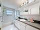 Bathroom featuring tiled shower and vanity at 7135 Trenton Pl, New Port Richey, FL 34653