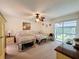 Bedroom with two beds, sliding glass doors, and leaf ceiling fan at 7135 Trenton Pl, New Port Richey, FL 34653