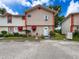 Charming townhome with brick facade, red awnings, and well-maintained landscaping at 7135 Trenton Pl, New Port Richey, FL 34653