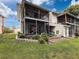 The two-story home's exterior features a screened lanai, perfect for outdoor living and entertaining at 7135 Trenton Pl, New Port Richey, FL 34653