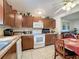 Well-lit kitchen featuring matching wood cabinets and granite counters at 7135 Trenton Pl, New Port Richey, FL 34653