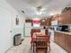 Cozy eat-in kitchen with tile floors, wood cabinets and white appliances at 7135 Trenton Pl, New Port Richey, FL 34653