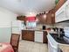 Charming kitchen featuring granite counters, wood cabinets and tile flooring at 7135 Trenton Pl, New Port Richey, FL 34653