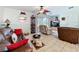 Comfortable living room with ceiling fan, tile floors, and sliding glass door to screened porch at 7135 Trenton Pl, New Port Richey, FL 34653