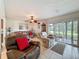Cozy living room with tile flooring and sliding glass doors to a screened patio at 7135 Trenton Pl, New Port Richey, FL 34653