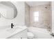 Elegant bathroom with marble-tiled walls, modern fixtures, and a bathtub with shower at 7192 Catalina St, Spring Hill, FL 34606