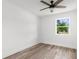 This bedroom includes wood-look floors, a ceiling fan, and a window at 7192 Catalina St, Spring Hill, FL 34606