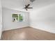Serene bedroom featuring hardwood floors, a modern ceiling fan, and neutral walls at 7192 Catalina St, Spring Hill, FL 34606