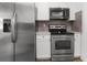 Well-equipped kitchen with stainless steel appliances, white cabinets, and countertops at 7192 Catalina St, Spring Hill, FL 34606