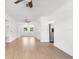Bright, airy living area with light hardwood floors, ceiling fans, and neutral paint at 7192 Catalina St, Spring Hill, FL 34606