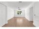 Open living room with hardwood floors, natural light, ceiling fan and neutral paint at 7192 Catalina St, Spring Hill, FL 34606