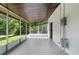 Enclosed porch with concrete flooring and screened walls at 7192 Catalina St, Spring Hill, FL 34606