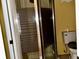 Bathroom featuring tiled shower with sliding glass doors and adjacent toilet at 723 W Bayshore Dr, Tarpon Springs, FL 34689