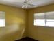 Bedroom with two windows offering natural light, wood-look flooring, and a ceiling fan at 723 W Bayshore Dr, Tarpon Springs, FL 34689
