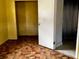 Bedroom featuring tile flooring and doorway to bathroom and closet at 723 W Bayshore Dr, Tarpon Springs, FL 34689
