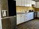 Updated kitchen featuring stainless steel appliances, modern white cabinets, and dark floors at 723 W Bayshore Dr, Tarpon Springs, FL 34689