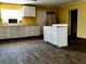 Kitchen featuring white cabinets, light countertops, stainless steel appliances, and dark floors at 723 W Bayshore Dr, Tarpon Springs, FL 34689