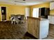Open kitchen with a dining area, featuring white cabinets, new appliances, and dark floors at 723 W Bayshore Dr, Tarpon Springs, FL 34689