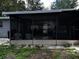 Expansive screened porch with seating, offering an ideal space for relaxation and enjoying the outdoors at 723 W Bayshore Dr, Tarpon Springs, FL 34689