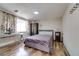Comfortable bedroom featuring a bed and desk near the window at 7412 Bellows Falls Ln, Hudson, FL 34667