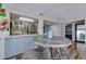 Dining area adjacent to the kitchen, featuring a round table with seating and wood-look floors at 7412 Bellows Falls Ln, Hudson, FL 34667
