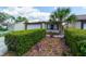 Inviting home boasts a well-manicured lawn, mature trees, and a private driveway leading to an attached garage at 7412 Bellows Falls Ln, Hudson, FL 34667