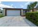 Charming home boasts a well-maintained exterior, spacious driveway, and lush front landscaping, creating a welcoming curb appeal at 7412 Bellows Falls Ln, Hudson, FL 34667