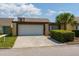Attractive home with a spacious driveway and a verdant bush, perfect for a Gathering, complemented by a well-maintained lawn at 7412 Bellows Falls Ln, Hudson, FL 34667