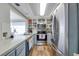 Cozy kitchen with stainless steel appliances, ample cabinet space, and wood-look floors at 7412 Bellows Falls Ln, Hudson, FL 34667